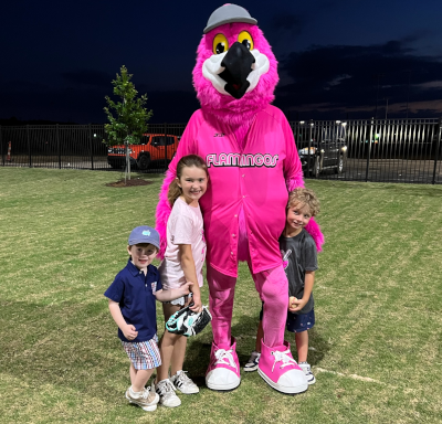 Florence Flamingo with smiling young children.