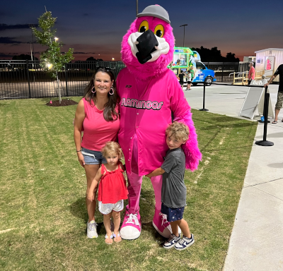 Florence Flamingo with smiling young children and Kacie Coker.