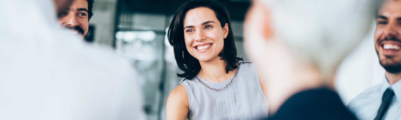 A young businesswoman shaking hands with someone out of frame