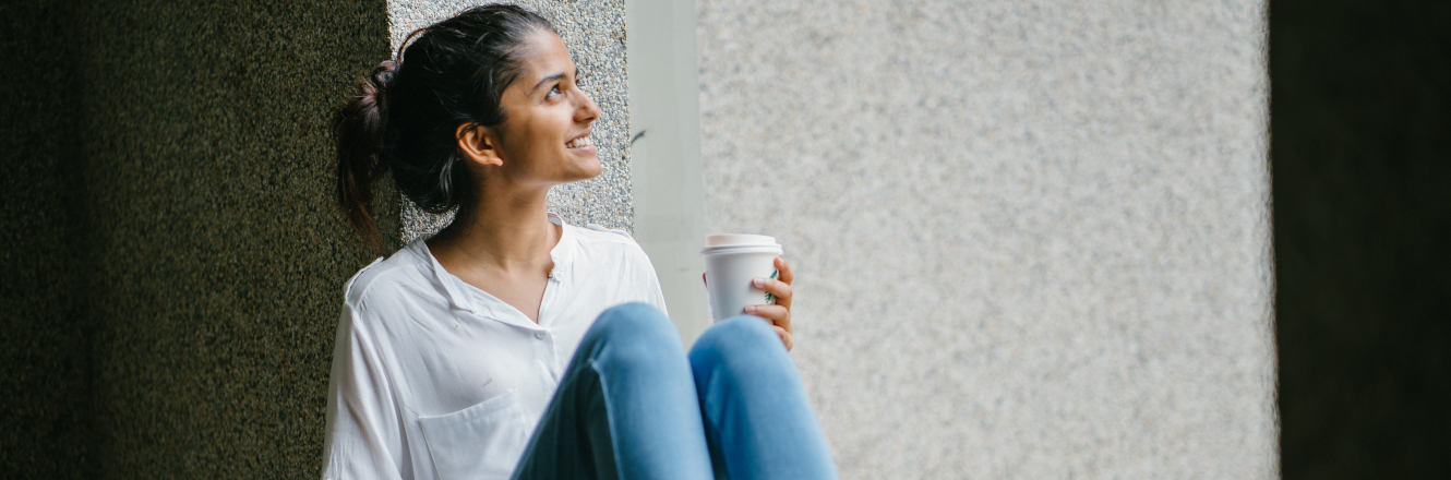 Woman Drinking Coffee with a Smile