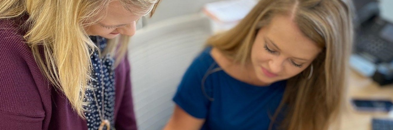 Two women working in the Carolina Bank Loan Department