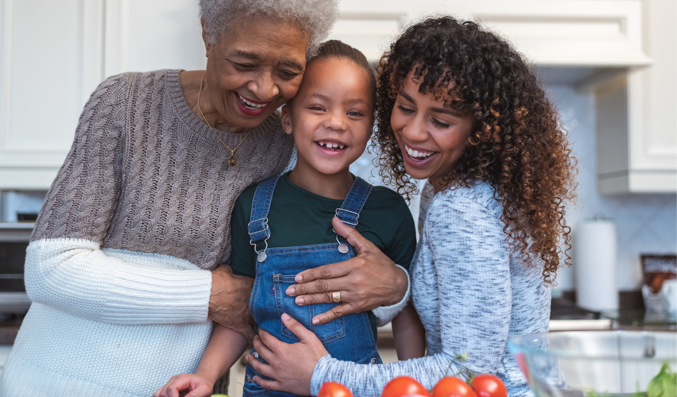 Smiling family hugging in the kitchen. 