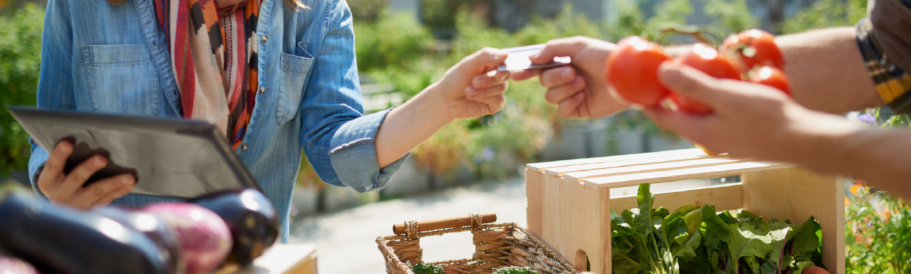 Close up of people's hands exchanging a credit card